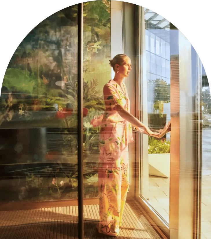 Lady looking out of SO Uptown Hotel Window